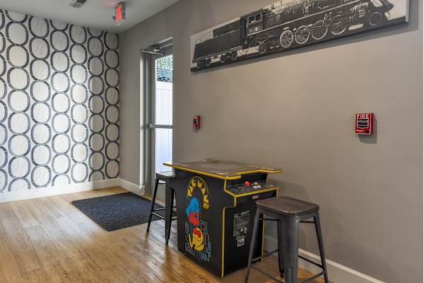 a game room with a foosball table and two stools